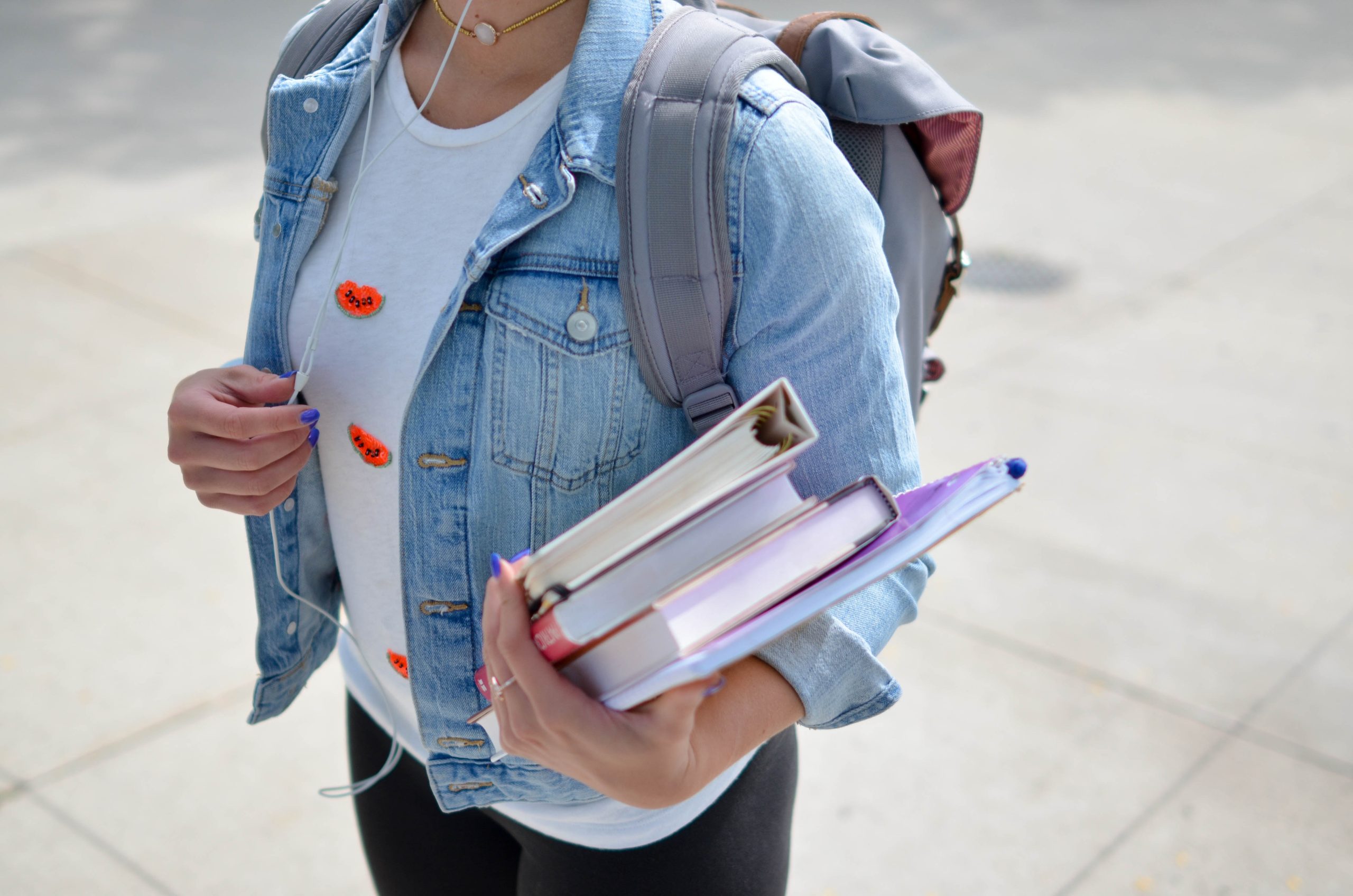 Female college student on campus holding textbooks