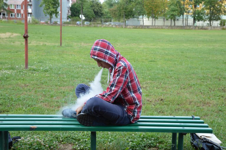 teenager vaping in park