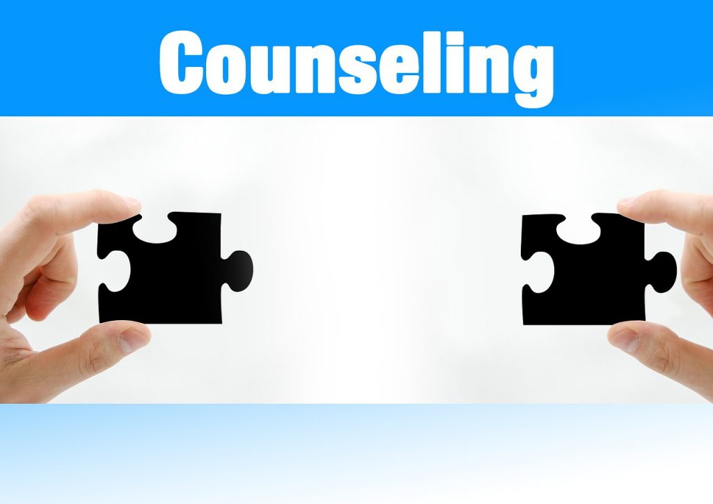 The word counseling above two hands holding puzzle pieces