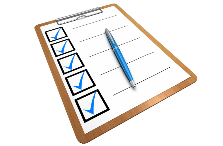 A checklist with five blue check marks, on a clipboard. A blue pen sits on the sheet.