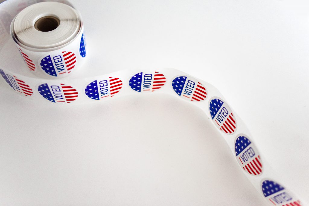 A roll of I Voted stickers unravels.