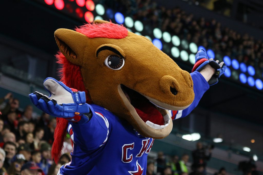 A horse mascot holds up his arms